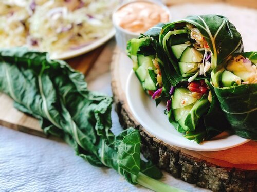 raw vegan collard green wrap on a white plate