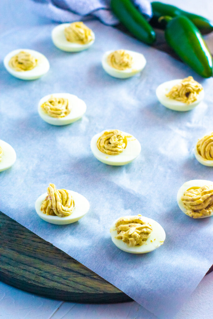 deviled eggs sitting on white parchment paper