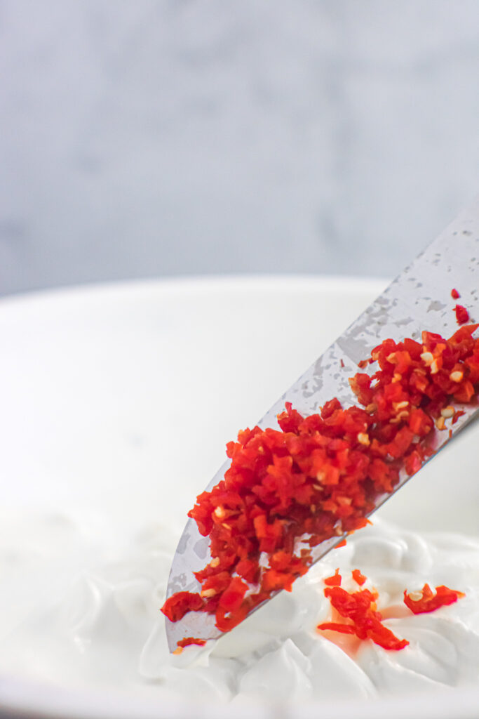 Chopped ghost peppers on a knife. 