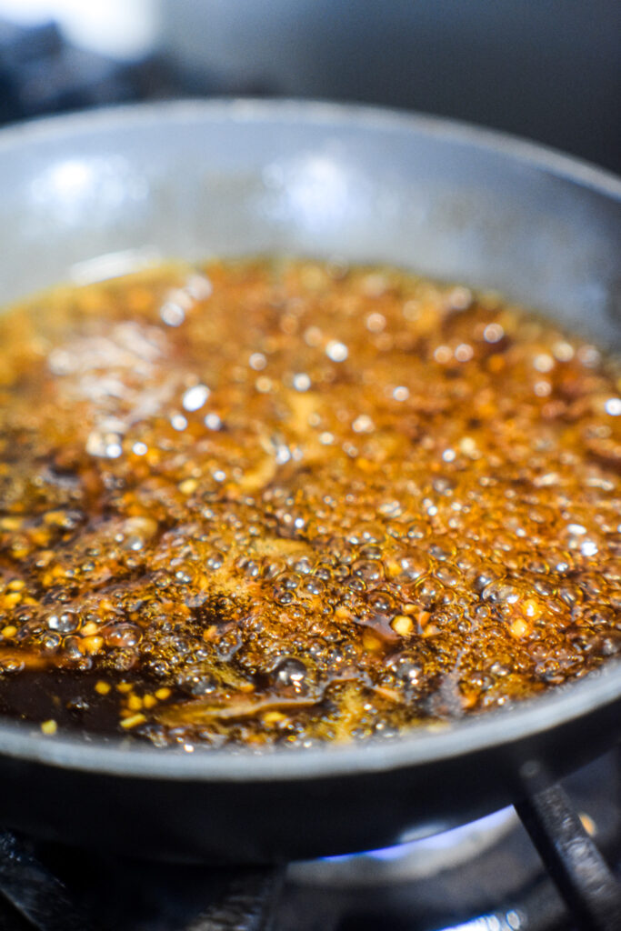 Orange sesame sauce in a small pan